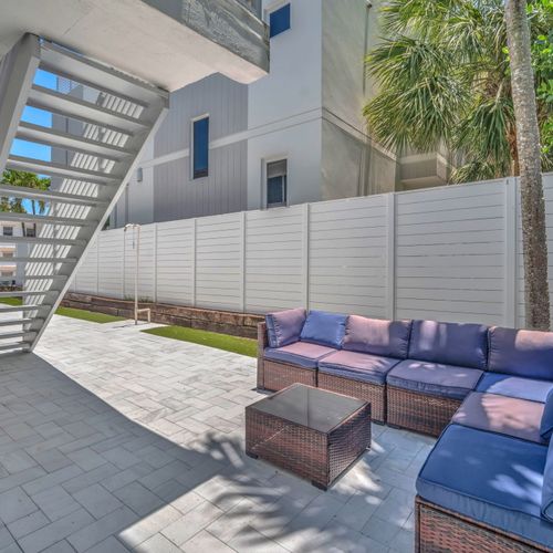Shared backyard seating area featuring a cozy sectional sofa.