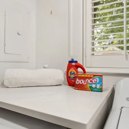 A compact little laundry nook tucked right between the kitchen and bunk room