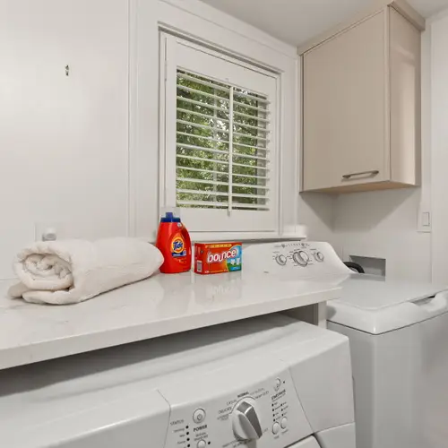 A compact little laundry nook tucked right between the kitchen and bunk room