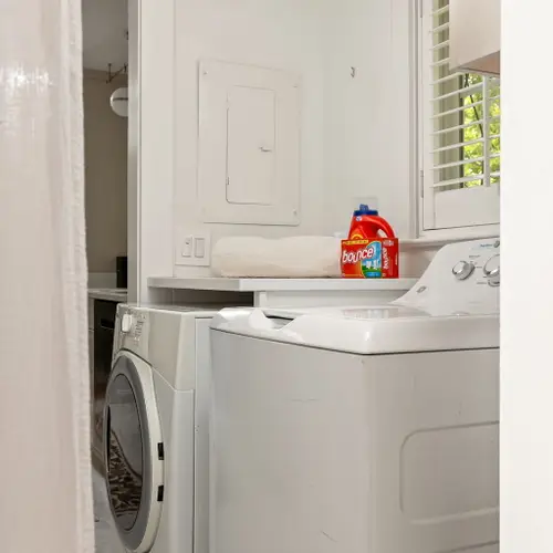 A compact little laundry nook tucked right between the kitchen and bunk room