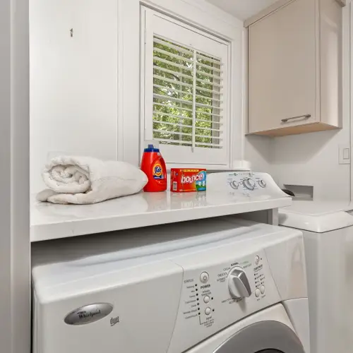 A compact little laundry nook tucked right between the kitchen and bunk room