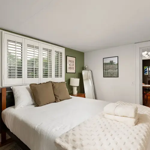 Queen bed, soft light, and zero reason to set an alarm