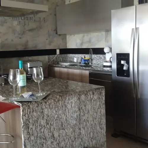 Modern kitchen with breakfast bar and stainless fridge