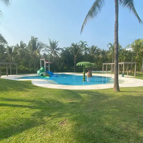 Lush lawns and pool within the resort gardens