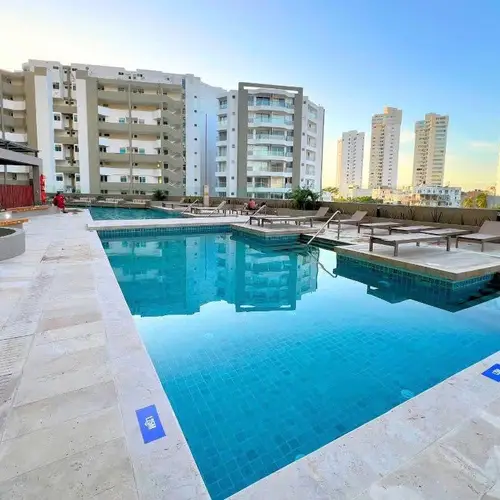 Pool deck with loungers at golden hour