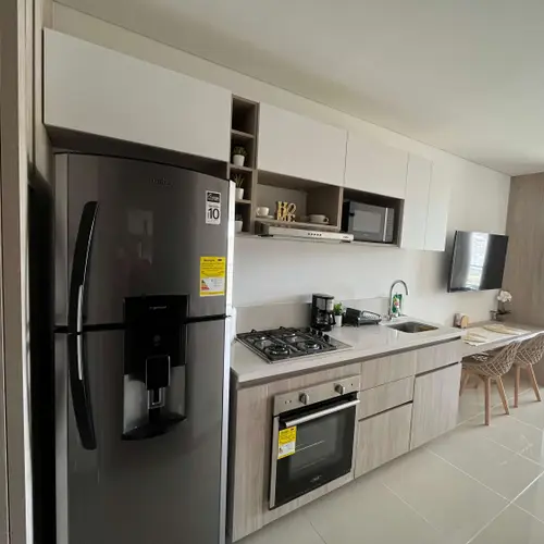 Kitchen with fridge, oven, gas stove and microwave