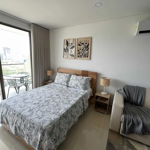 Double bed with fresh linens and balcony access
