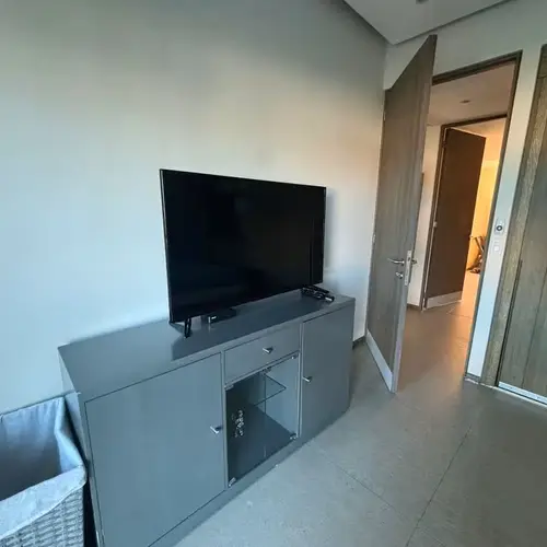 Bedroom with smart TV and dresser