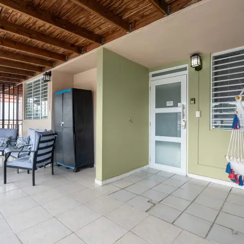 Covered terrace with seating and hanging hammock chair