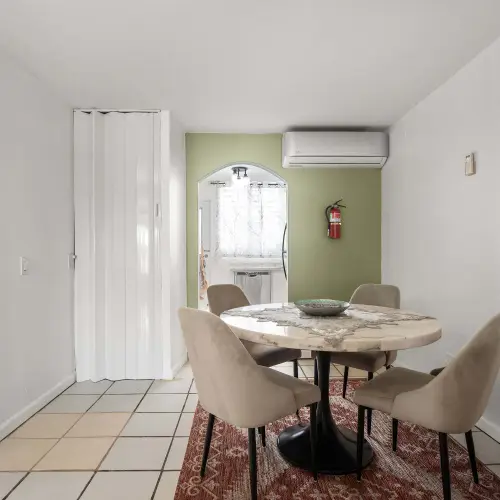 Dining area with round table and A/C