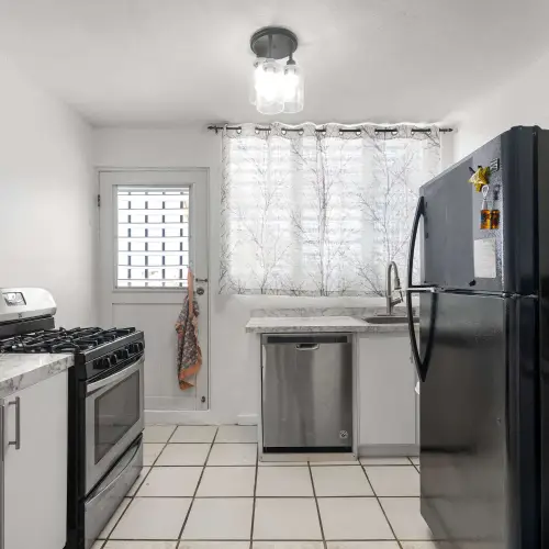 Kitchen with gas stove and refrigerator