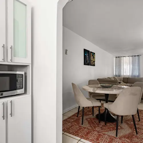 Kitchen with built-in microwave, open to dining area