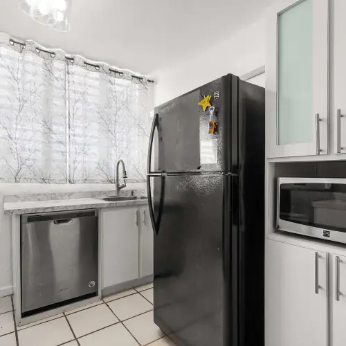 Kitchen with refrigerator, microwave and dishwasher
