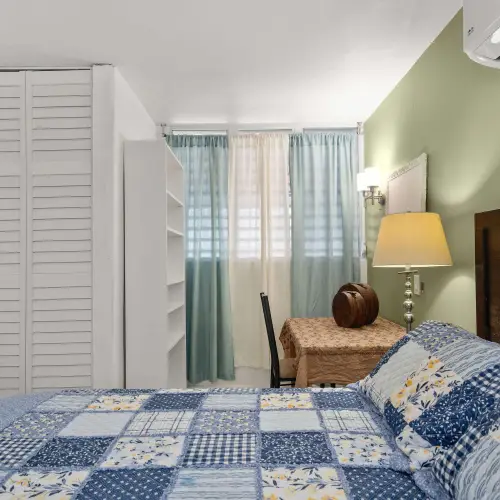 Bedroom 1 with queen bed, nightstand and lamp