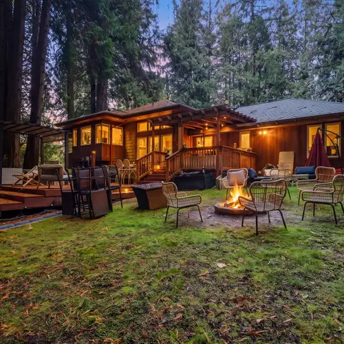 Unwind outdoors and take in the quiet beauty of the property, beautifully lit as evening settles in.