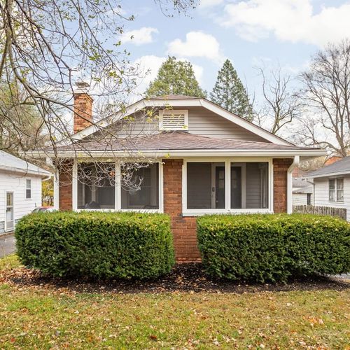 Charming Exterior: Experience a welcoming facade surrounded by lush greenery and cozy neighborhood vibes!