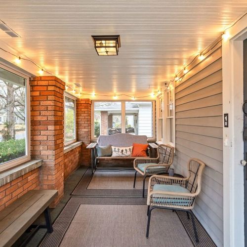 Screened Porch: Unwind with friends in this charming space, adorned with twinkling lights and comfy seating.