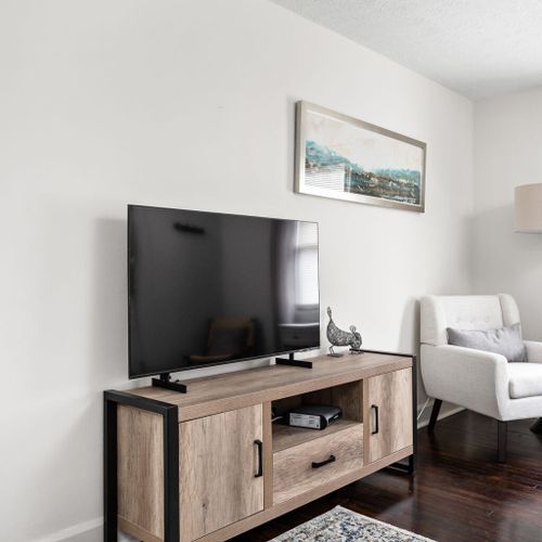 Living Room: Relax and unwind in a bright space featuring stylish decor and a sleek TV setup!