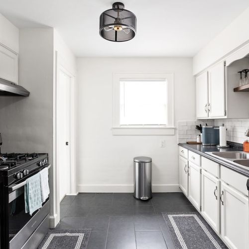 Kitchen: Bright and airy space with modern appliances, sleek countertops, and stylish decor!
