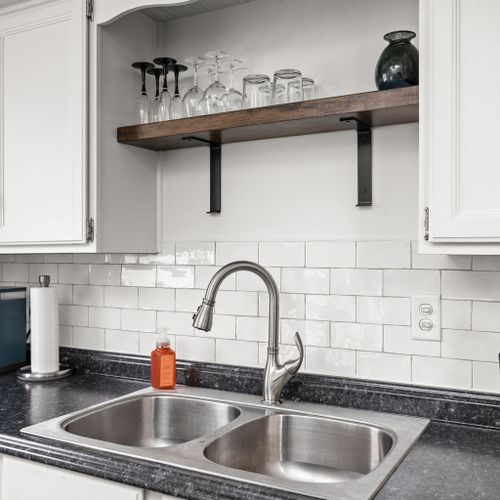 Kitchen: Sleek surfaces and well-organized charm make meal prep a delight in this modern kitchen!