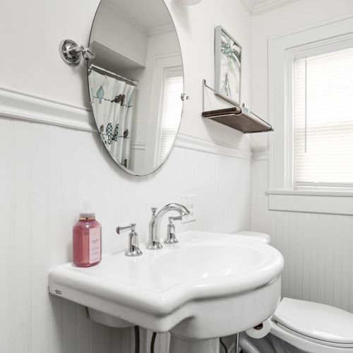 Bathroom: Bright space with stylish fixtures, delightful decor, and inviting natural light!