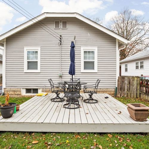 Exterior: Step into charm with a welcoming porch and lush greenery in tranquil Indianapolis!