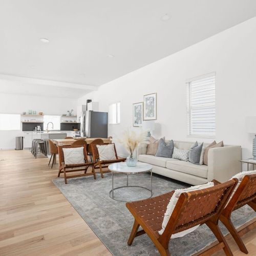 Living Area: Spacious sanctuary with modern decor and warm wood accents for memorable gatherings!