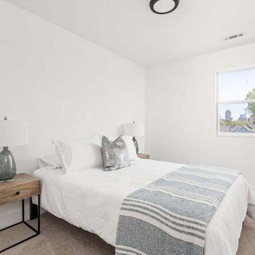 Bedroom: Bright and airy retreat with skyline views and stylish decor for a restful night.