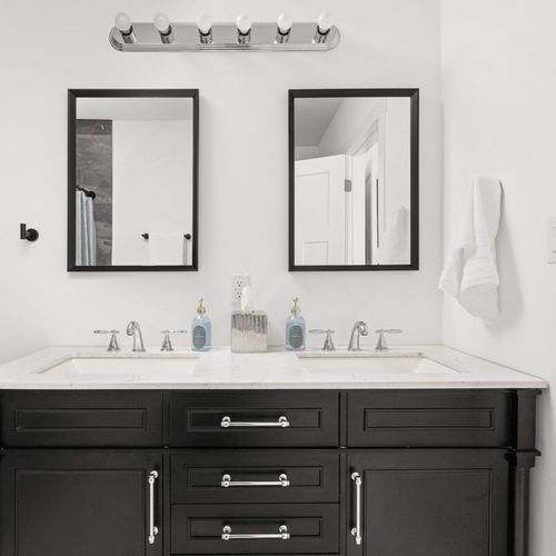 Master Bathroom: Sleek dual vanities and modern mirrors create a stylish retreat for your getaway!