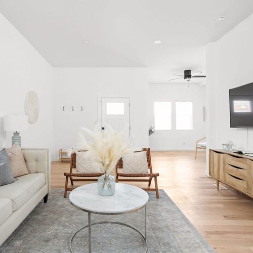 Living Room: Relax in style with bright windows, chic decor, and inviting seating for all!