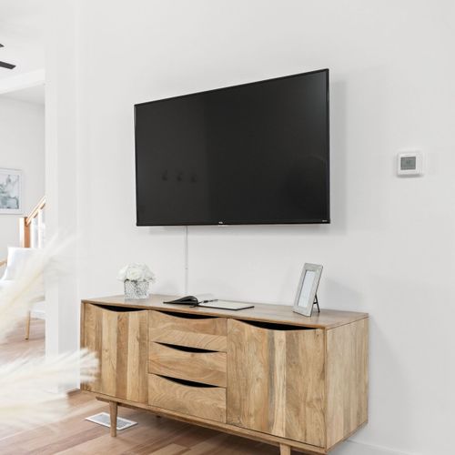 Living Room: Stream your favorite shows on a sleek TV with graceful storage beneath!