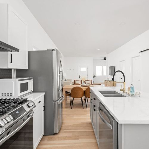 Kitchen: Modern design with sleek appliances, stunning countertops, and ample dining space awaits you!