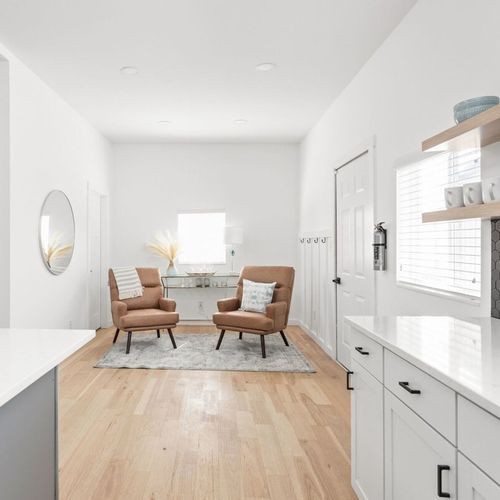 Charming Seating Nook: Bright space with stylish chairs and natural light for relaxation and chats!