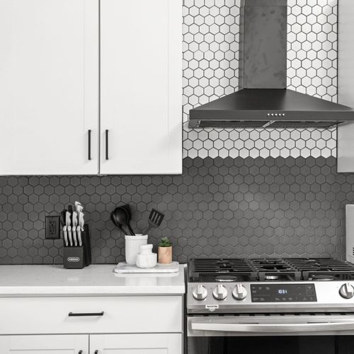 Kitchen: Sleek design with modern appliances and stylish hexagon tile for culinary creativity!