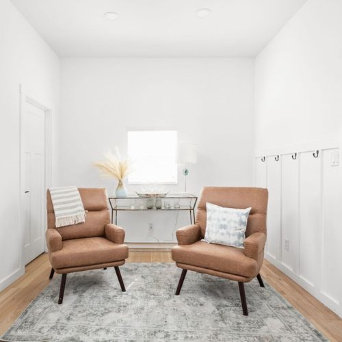 Charming Seating Nook: Bright space with stylish chairs and natural light for relaxation and chats!