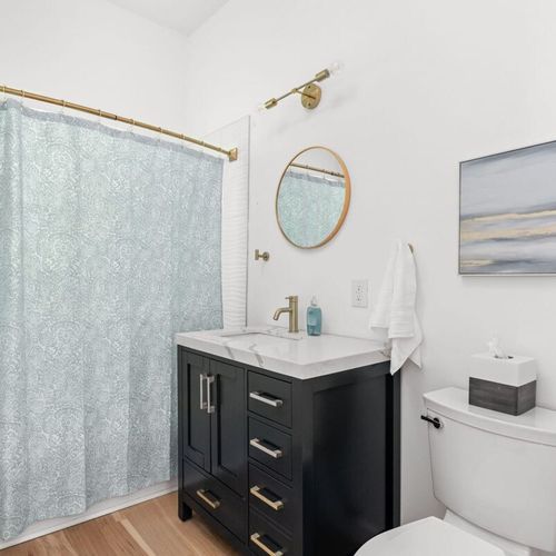 Stylish Bathroom: Enjoy a sleek vanity, elegant lighting, and refreshing decor for your retreat!