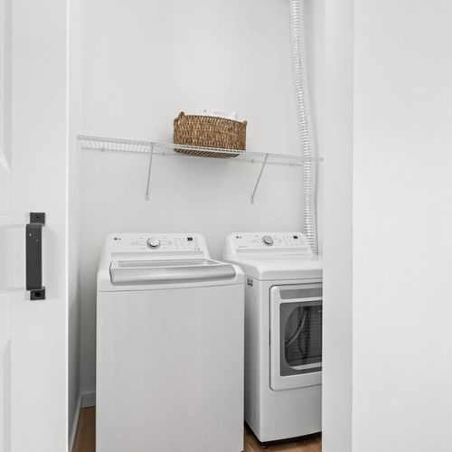 Laundry Room: Freshly laundered clothes await in this modern, efficiently designed space!