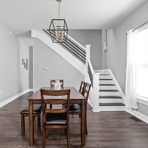 Stairs up to the bedroom on the left, coffee bar on the right and large dining table