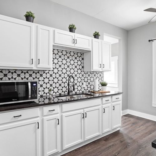 Beautiful farmhouse style kitchen with all of the essentials; cooking utensils, oil, salt and pepper, etc.