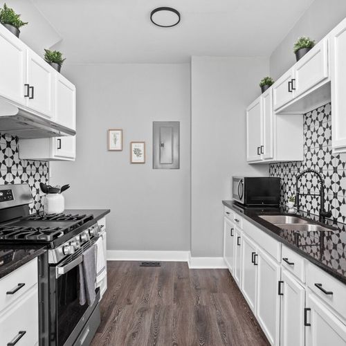 Beautiful modern kitchen with all of the essentials; cooking utensils, oil, salt and pepper, etc.