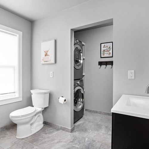 Bathroom with attached Laundry room with washer and dryer, ironing/folding station and provided detergent and softener for your convenience!