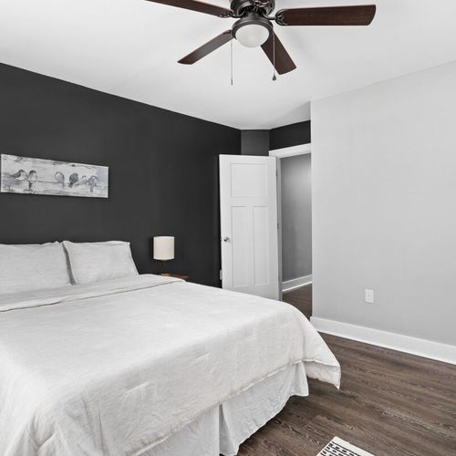 Enjoy the 2nd bedroom with tv, queen bed, dresser, and closet and beautiful accent wall!