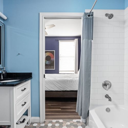 Our shower, tub, sink, vanity, in this attached bathroom are seamlessly bright and clean, ensuring your utmost comfort and enjoyment.