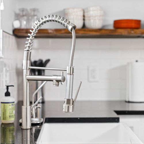Admire the gleaming, elegant faucet in the kitchen, adding a touch of sophistication to the space while ensuring cleanliness.