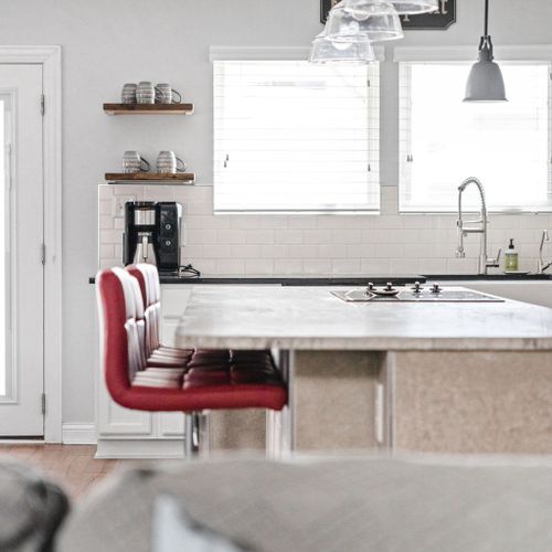 Our countertop boasts stylish seating arrangements and complementing lights above, creating a chic and inviting ambiance for your dining experience.