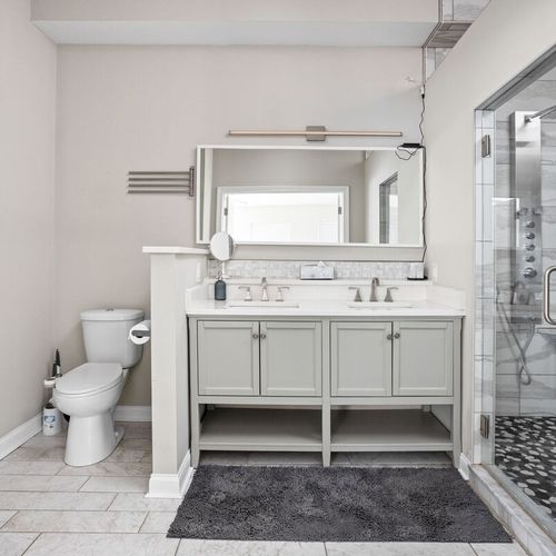 Enter into our elegantly shining bathroom, where cleanliness is paramount. Complete with a mirror, vanity cabinets, and essential bathroom amenities, it offers both style and functionality.