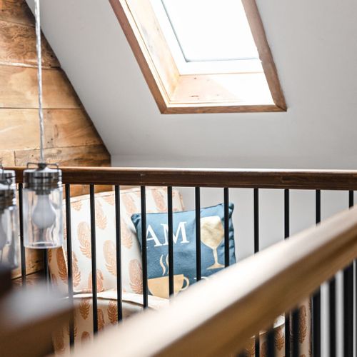 Relax in our cozy and comfortable seating area, bathed in natural light streaming in from the roof, creating a serene and inviting atmosphere.