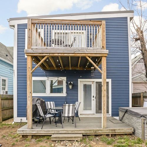Take pleasure in our fully fenced backyard, featuring a dining table set on the back porch, perfect for enjoying meals al fresco surrounded by nature.