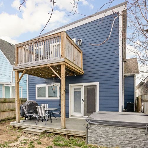 Take pleasure in our fully fenced backyard, featuring a dining table set on the back porch, perfect for enjoying meals al fresco surrounded by nature.