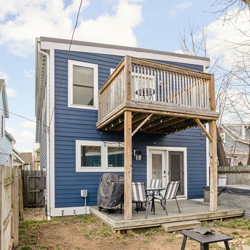 Take pleasure in our fully fenced backyard, featuring a dining table set on the back porch, perfect for enjoying meals al fresco surrounded by nature.
